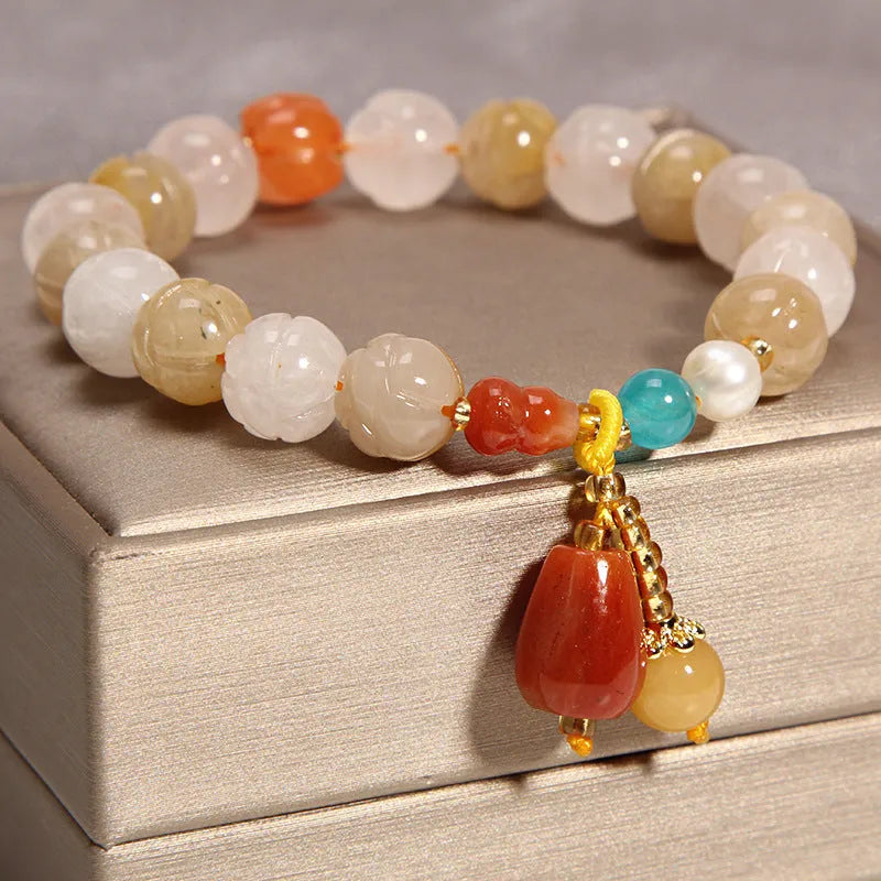 Khaki coloured crystal bead bracelet for women on a gold silk cord, showing Japanese and South Korean style.