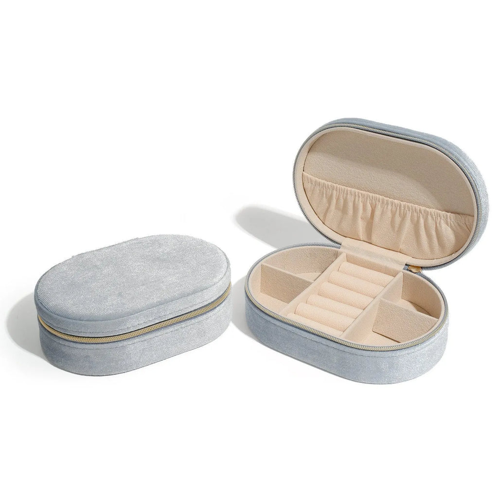 Oval velvet jewellery storage box in lake blue with flannel interior, measuring 15 cm long.