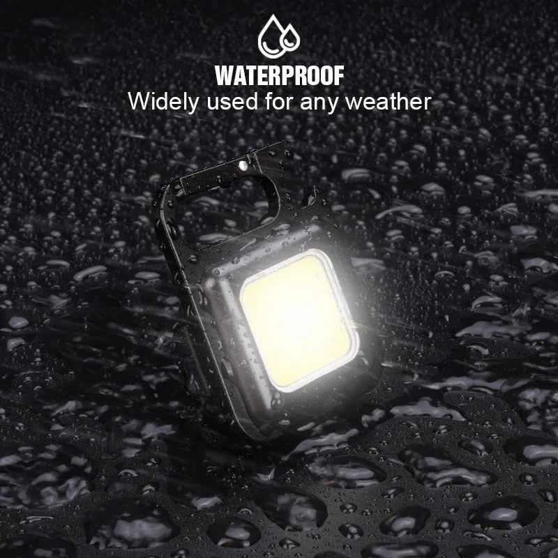 Black aluminium alloy USB rechargeable keychain light with LED, magnet, and folding handle