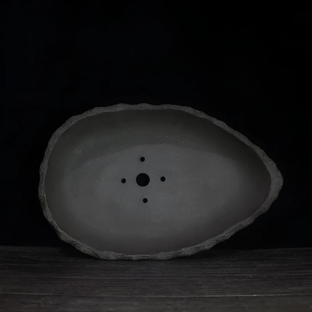 Handmade purple clay flower pot showing unique shape and texture with floor-standing design