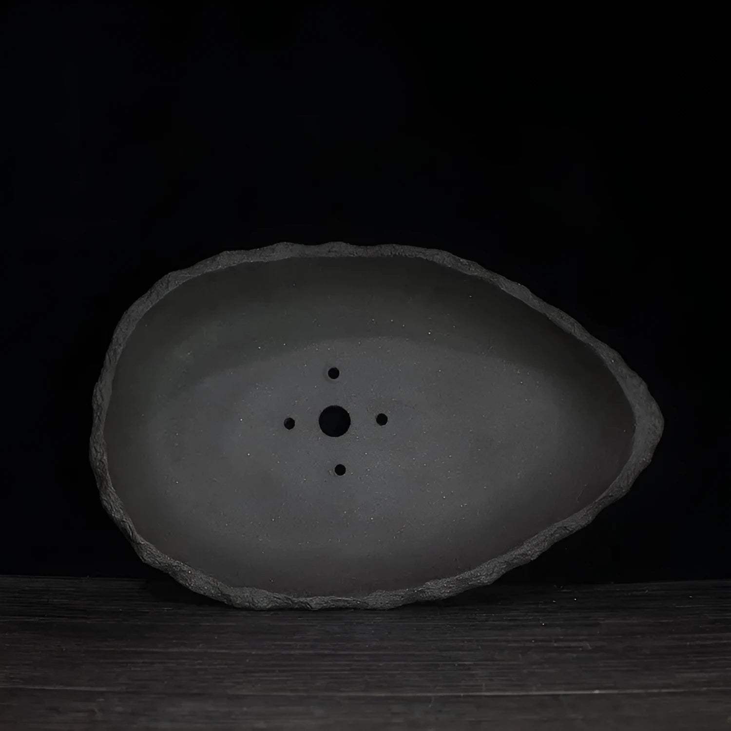 Handmade purple clay flower pot showing unique shape and texture with floor-standing design