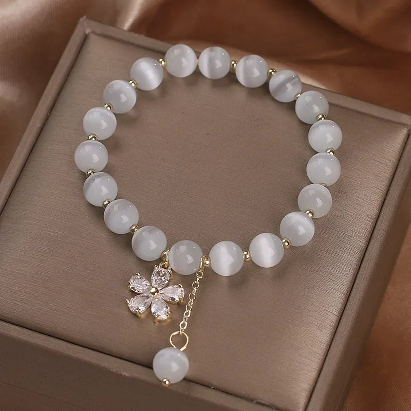 Women's white cat's eye stone bracelet with flower tassel pendant and safety buckle clasp