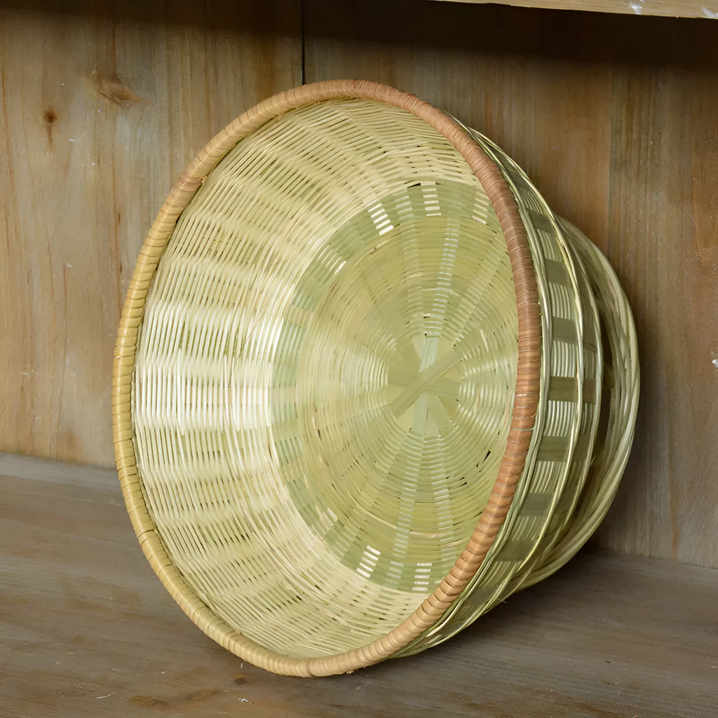 Handmade natural bamboo storage basket shown in a household setting.