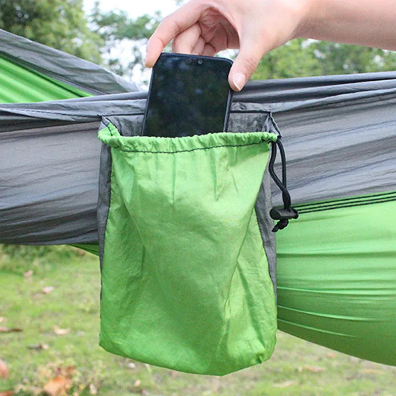 Blue nylon parachute cloth camping hammock hung between trees, showing its 270cm length.