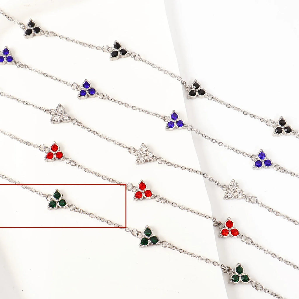 Women's geometric stainless steel bracelet with triple diamond design and coloured stone in gold or steel tone.