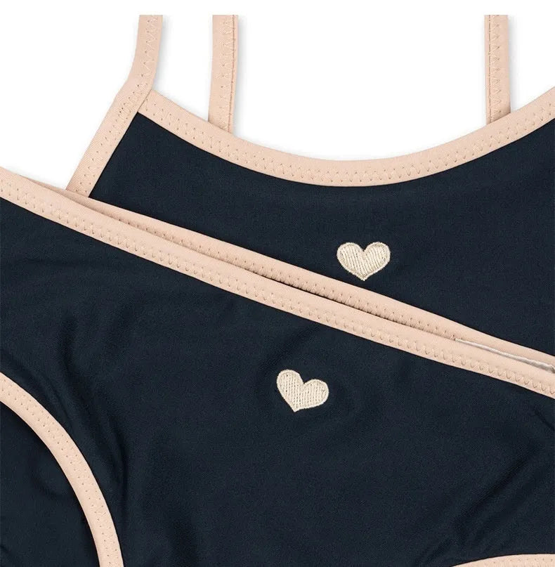 Dark blue split colour baby girls' swim briefs made from polyester and Lycra fabric.