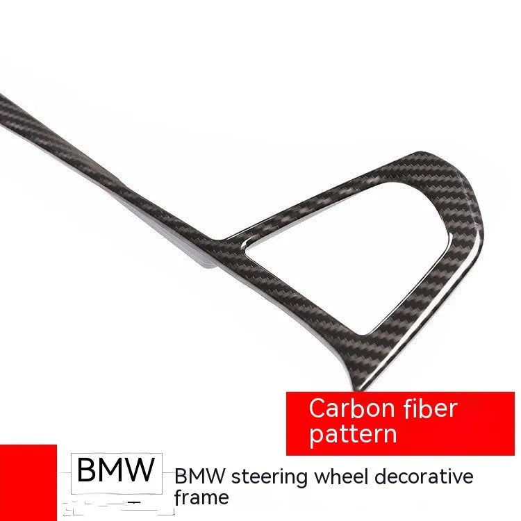 Carbon fibre pattern decorative frame for BMW steering wheel button trim.