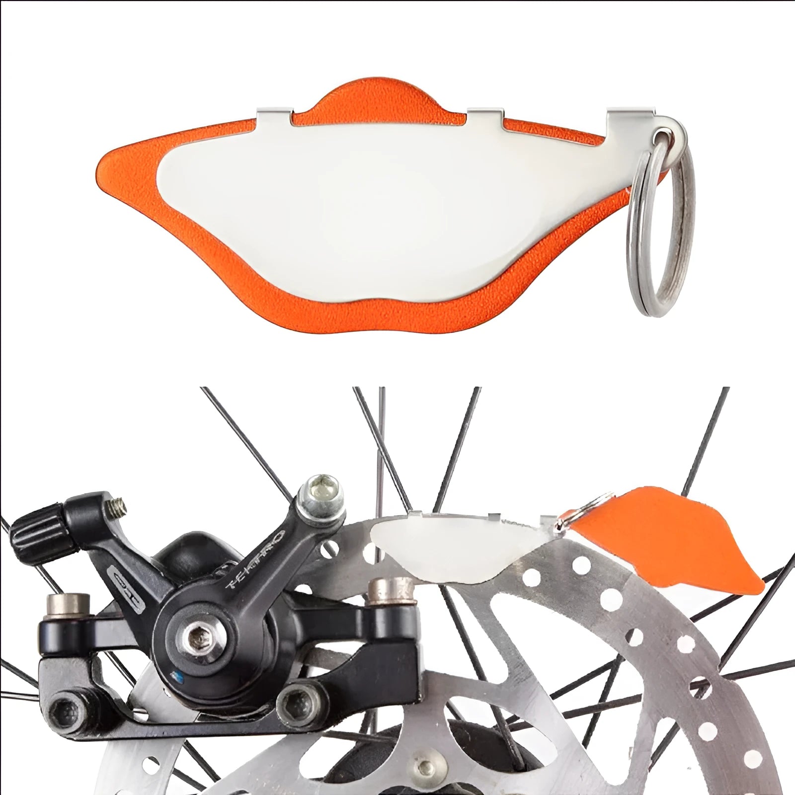 Black and orange metal mountain bike disc brake linings with adjustment flap on a neutral background.