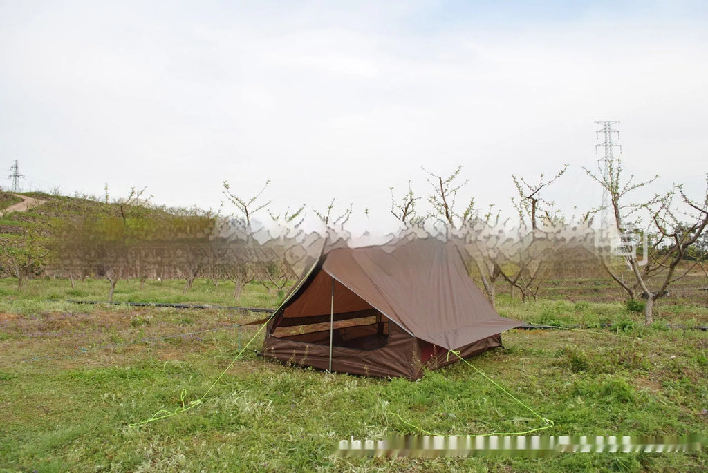 Brown A-line cabin tent setup with hiking pole supports showing spacious interior and waterproof fabric construction