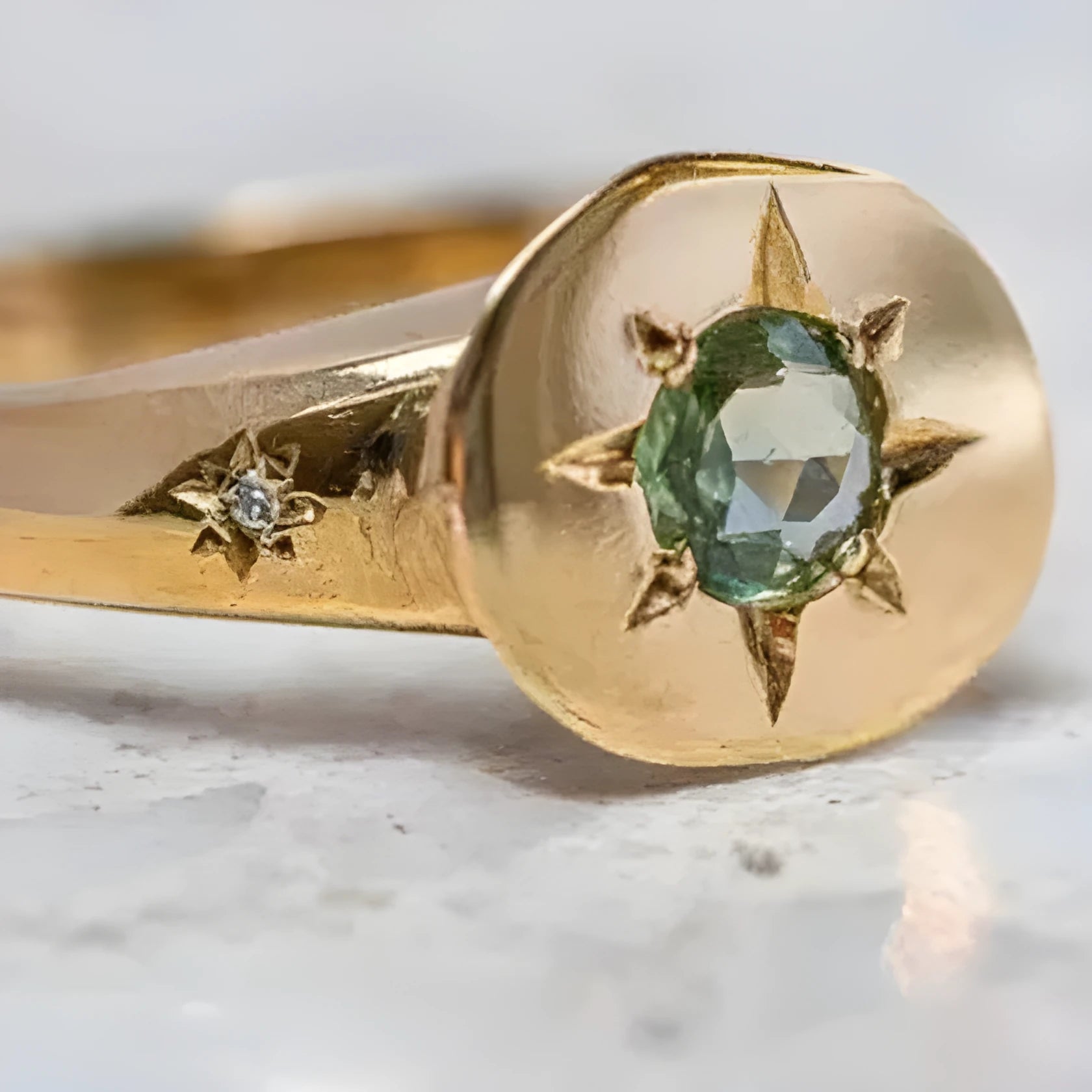 Gold ring with star-shaped asterism pattern and adjustable opening.