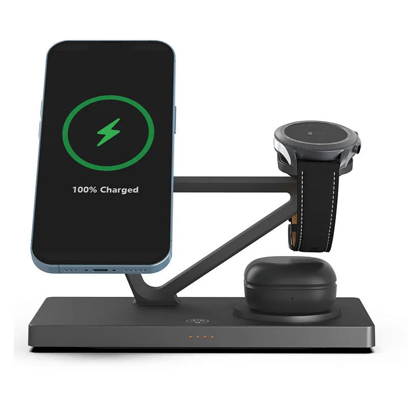 White 5-in-1 wireless charging station with magnetic phone holder, smartwatch pad, and glowing RGB night light on a wooden desk.