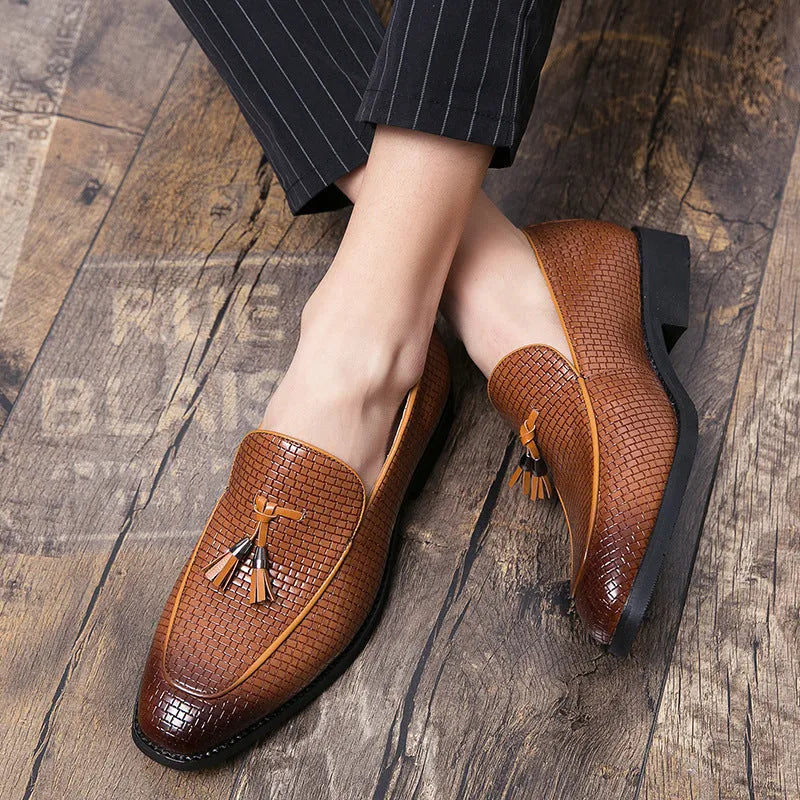 Men's black pointed slip-on shoe with a tassel on a business-style artificial PU upper.