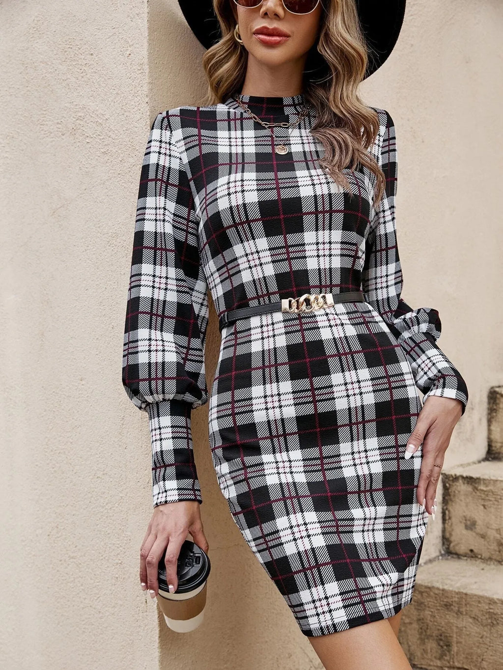 Black tight dress with lantern sleeves and printed design featuring leather stitching detail
