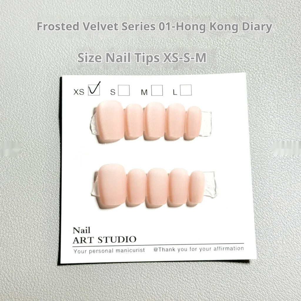 Set of frosted velvet false nails with Cat's Eye reflection in short ladder shapes on a display stand.