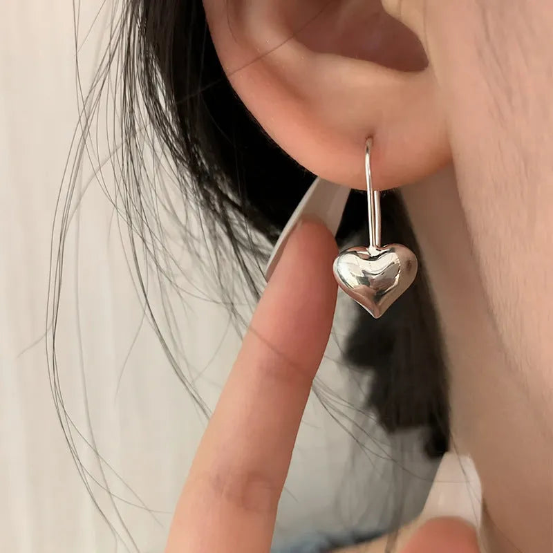 Silver-coloured heart-shaped earrings with 3D glossy design and Korean-style elements