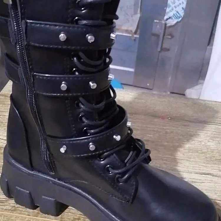 Women's black mid-calf boots with side zip and metal buckle detail on a white background.