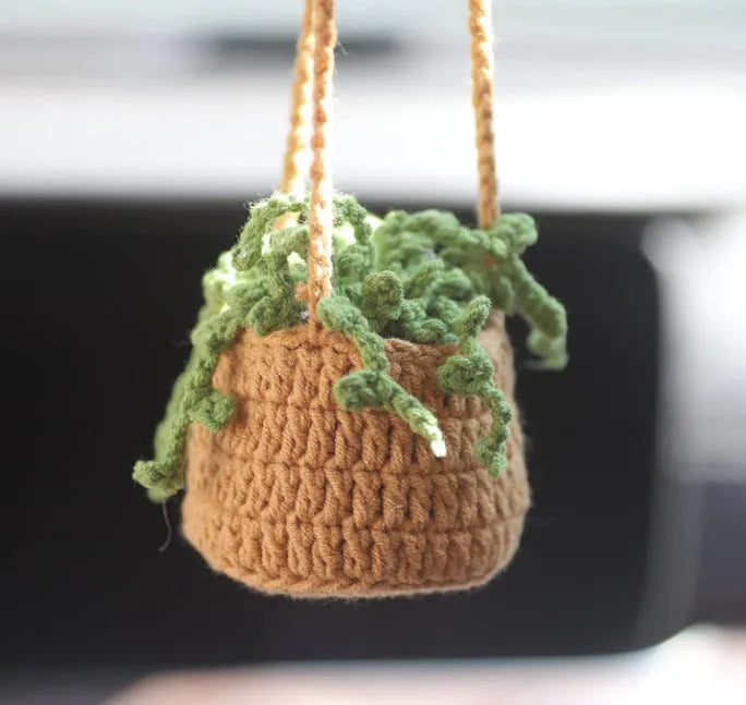 Knitted green and white car plant decoration with hanging rope