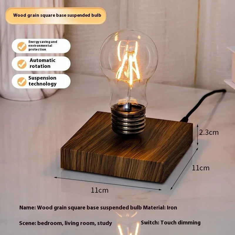 Creative small iron art night lamp with suspension bulb design on a black wood grain base.