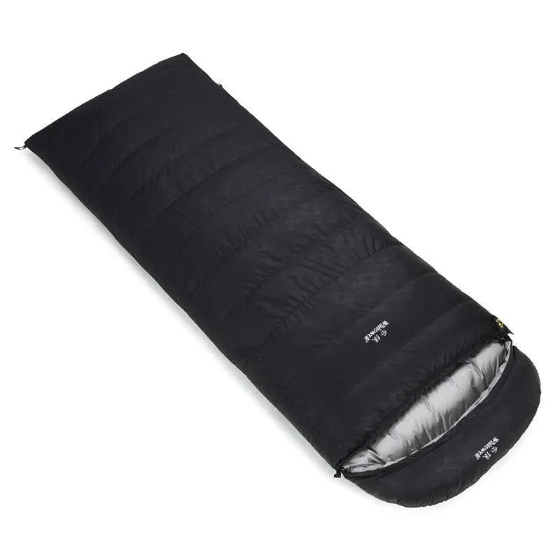 Black outdoor sleeping bag with envelope structure and goose down fill on a campsite.