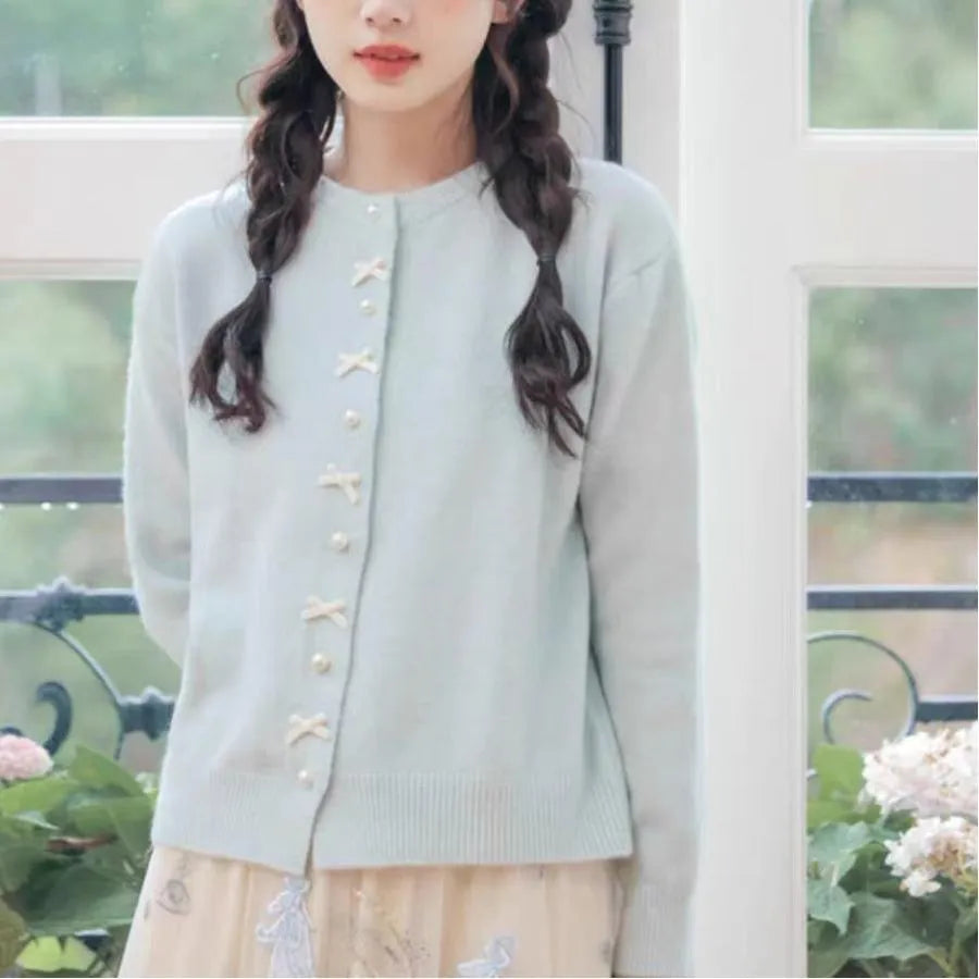 Women's solid colour sweater cardigan with bow detail and pearl buttons