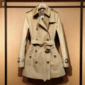 Khaki women's trench coat with double-breasted British styling and flight sleeves