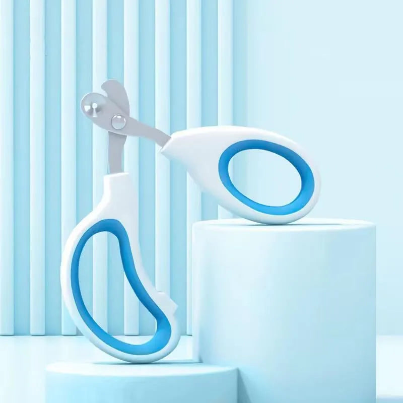 Blue pet nail clippers with circular cutting hole and non-slip handles on a white background.