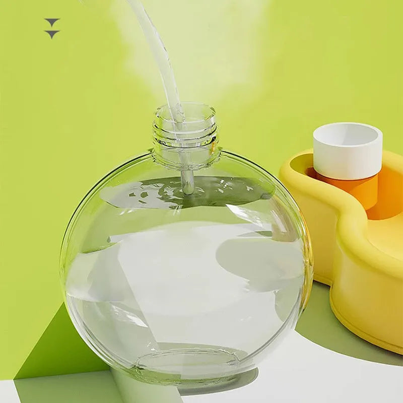 Green portable dog water bottle with pull-out bowl, shown next to orange and yellow versions.