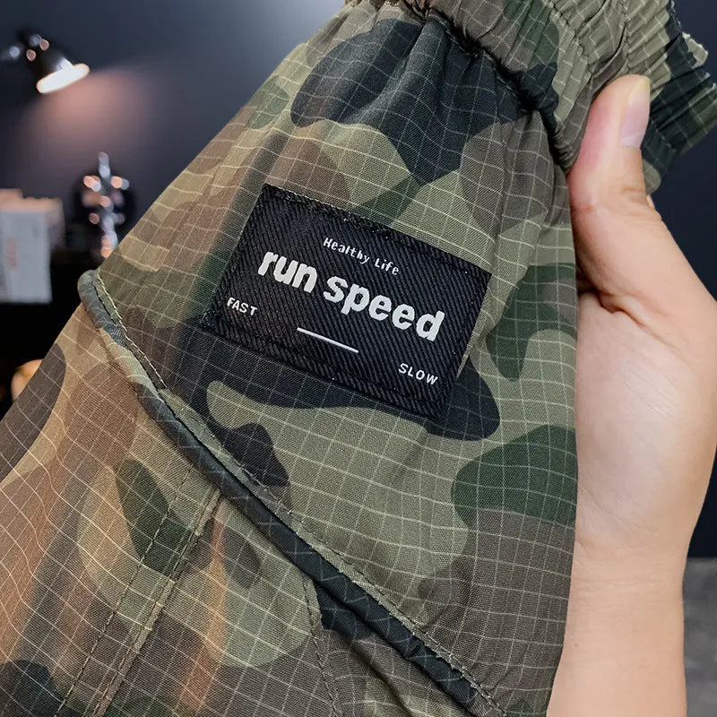Men's camouflage cargo shorts in loose fit with pockets, shown in khaki colour.