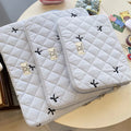 Laptop storage bag with rhombus embroidered bow decoration in nylon material showing colour options