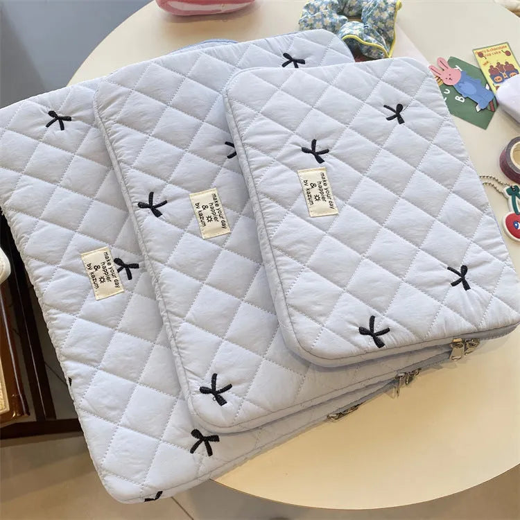 Laptop storage bag with rhombus embroidered bow decoration in nylon material showing colour options