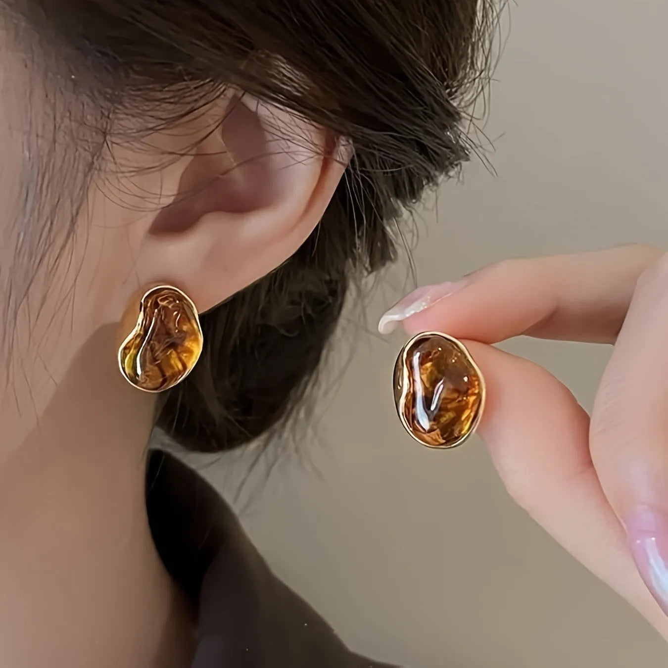 A set of three handmade geometric tassel earrings for women: Amber, round piece, and water drop styles.