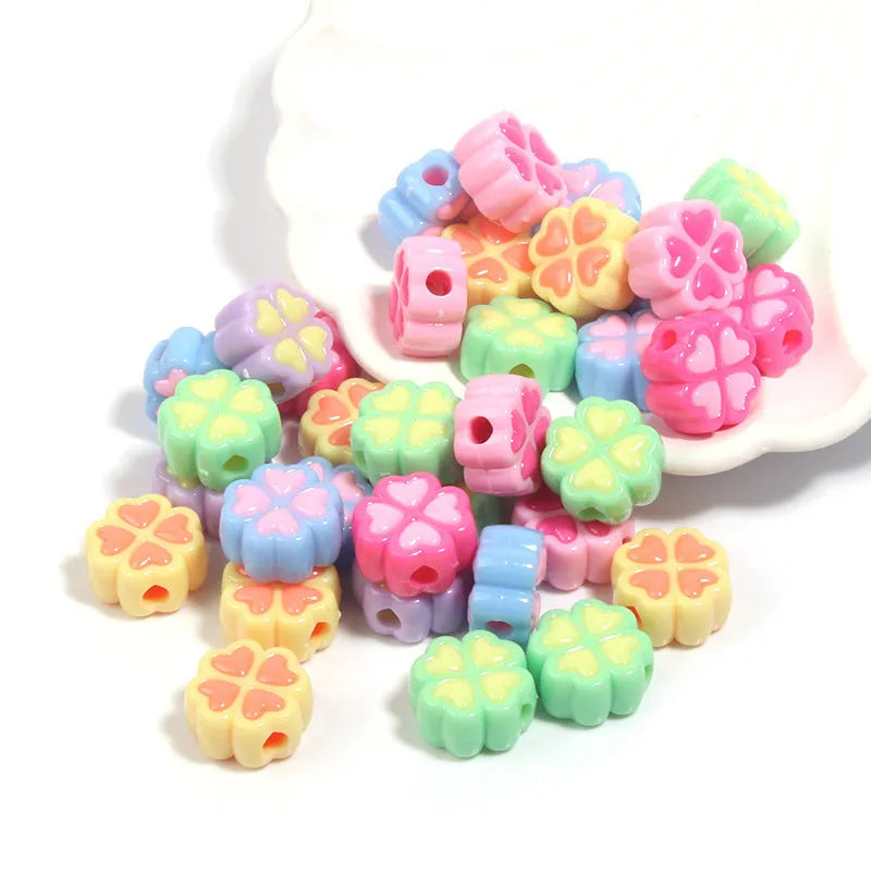 Assorted light-coloured acrylic clover-shaped beads with frosted finish, 15mm size.