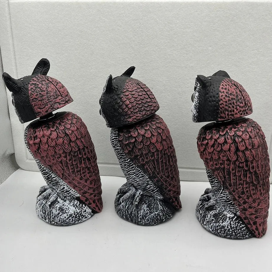 Artificial owl bird deterrent ornament with moving head in outdoor setting