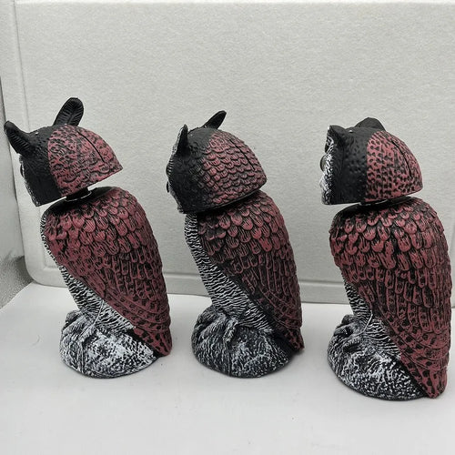 Artificial owl bird deterrent ornament with moving head in outdoor setting