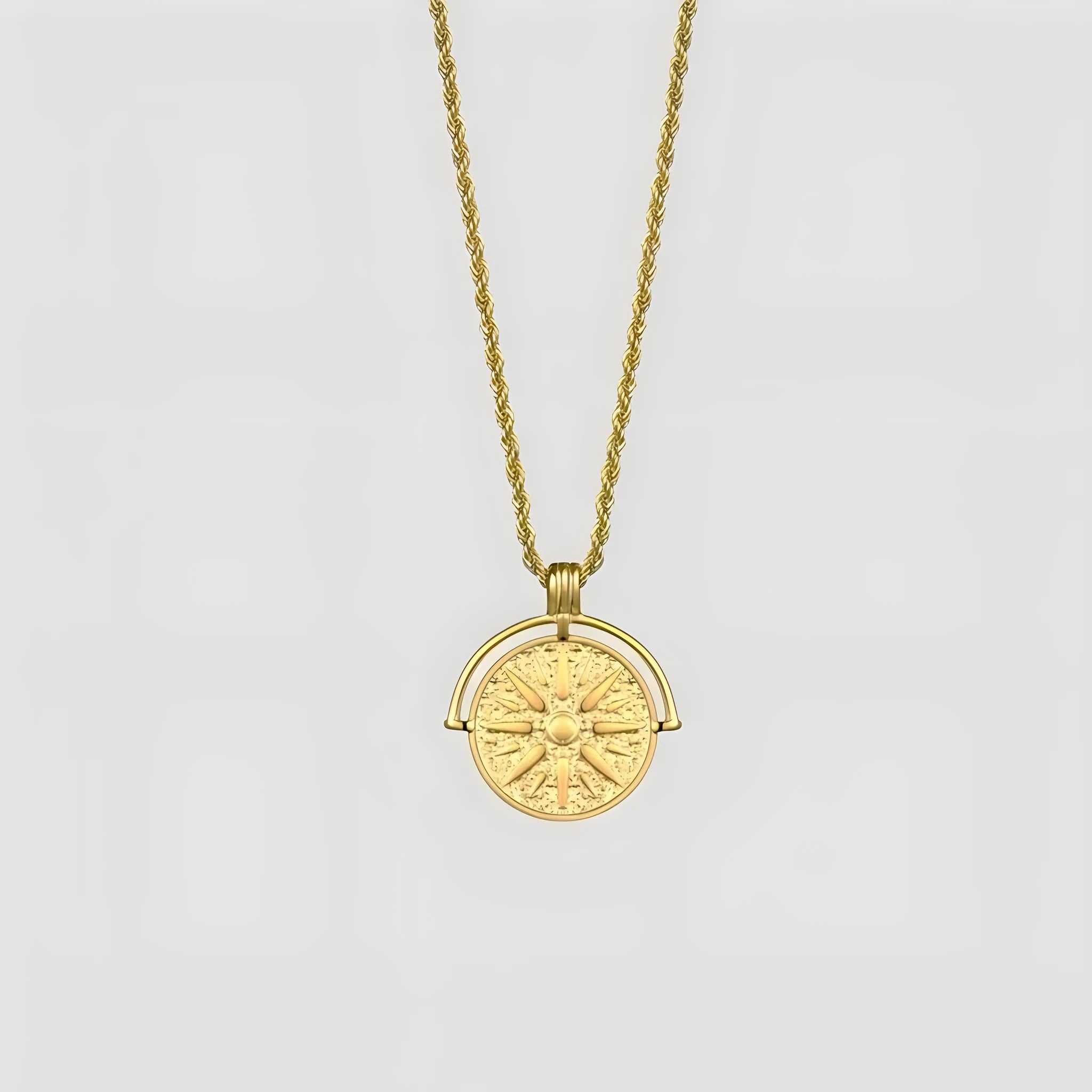 Gold titanium steel necklace with round embossed sunflower pendant and hemp chain.