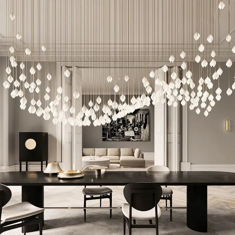 Ceramic magnolia petal-shaped single head pendant light with a dimmable fitting against a neutral background.