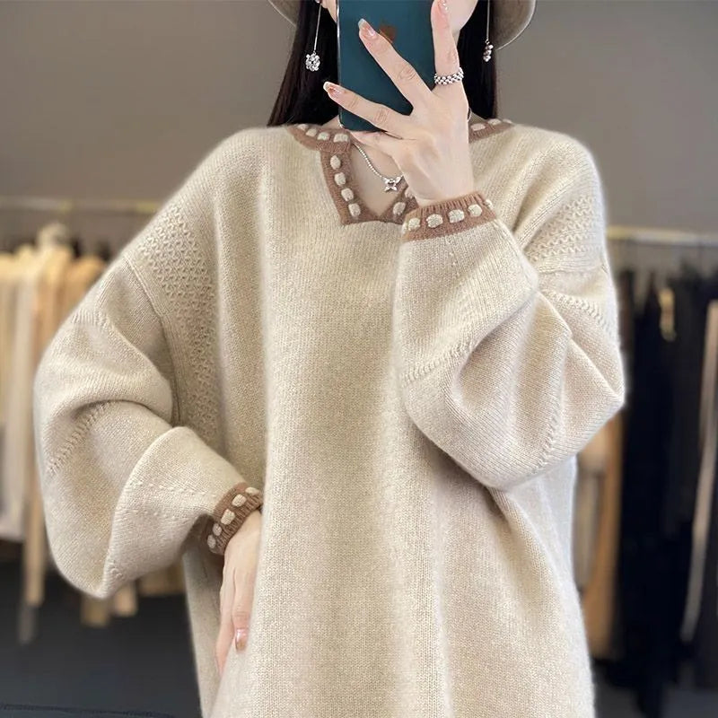 White women's V-neck long sleeve pullover sweater made from viscose knit fabric on a hanger.