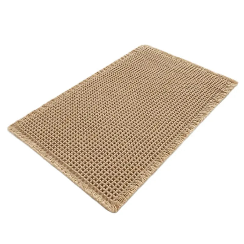 Square checkered polyester bathroom carpet on a tiled floor in a light grey colour.