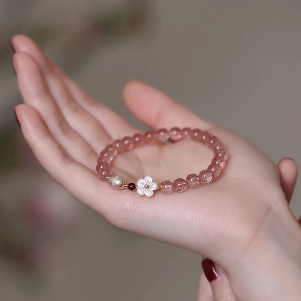 Strawberry quartz peach blossom bracelet with natural pink crystal flower beads for casual wear.