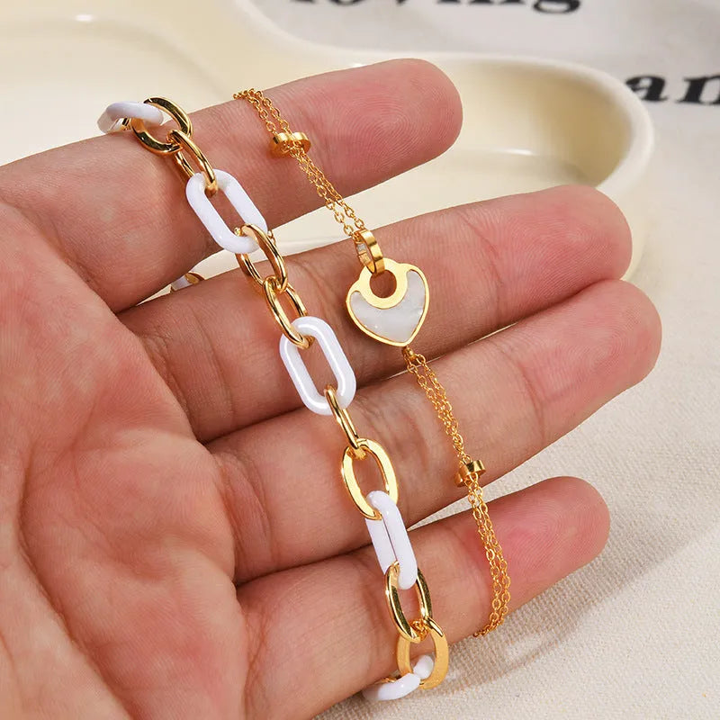 Stainless steel and resin bracelet for women with a double-layered heart-shaped charm.