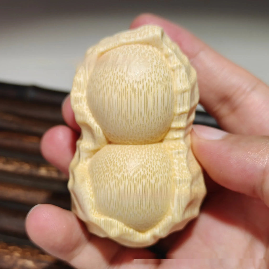 Solid natural bamboo peanut ornament with 'good things may happen' engraved message.