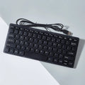 USB wired mini keyboard in black, white, pink or blue colours showing compact size