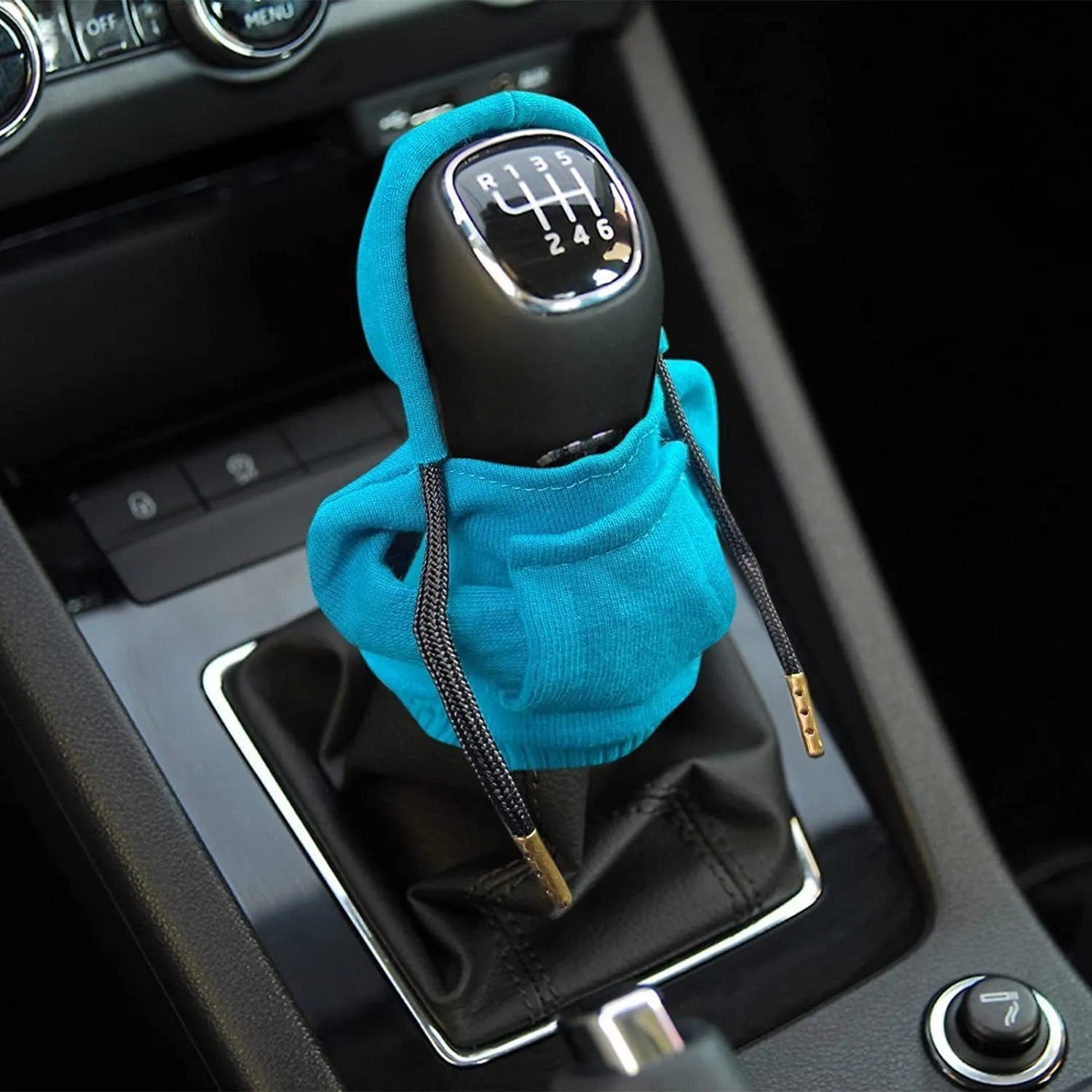 Blue cloth gear shift knob cover shown next to a car's manual gearstick.