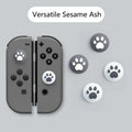 Nintendo Lite console with blue and green silicone joycon sleeves and textured cat claw thumbstick caps.