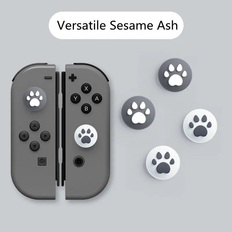 Nintendo Lite console with blue and green silicone joycon sleeves and textured cat claw thumbstick caps.