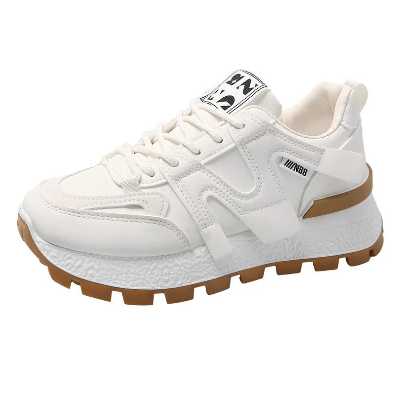 Unisex low-top sneaker in black with round toe, flat heel, and lace-up front on a rubber sole.