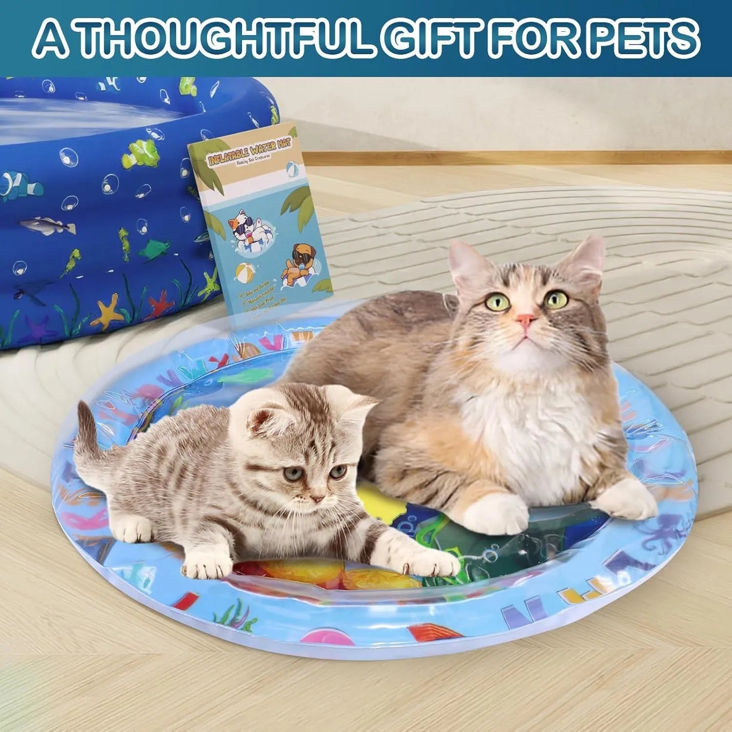 Square blue ocean-themed PVC water play mat for cats with floating fish toys inside, shown on a floor.
