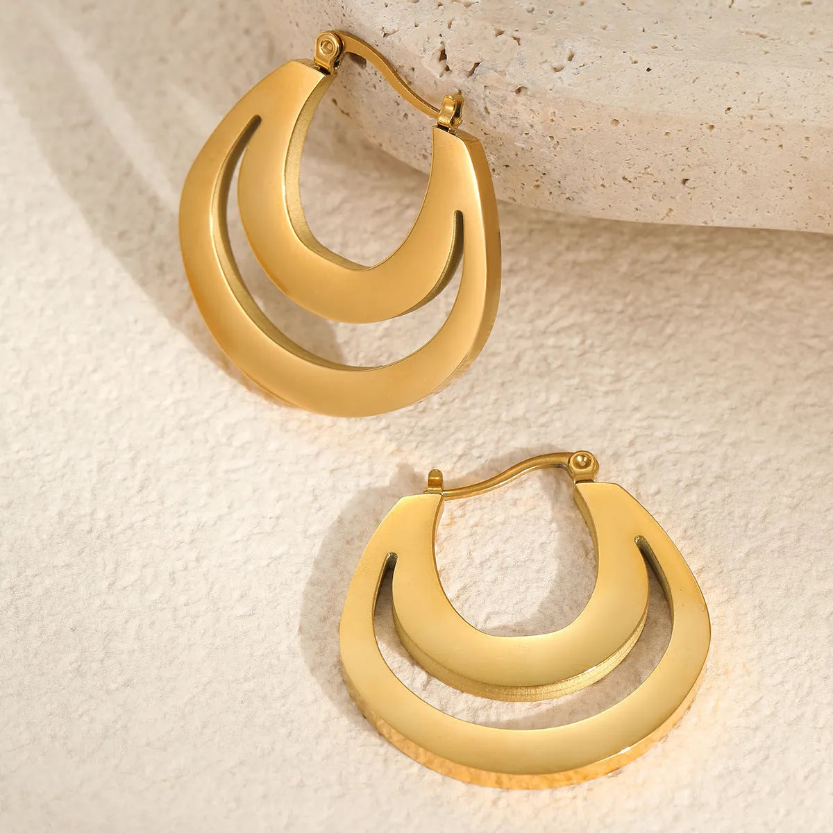 Geometric French earrings with circular ring design in gold and steel metallic finishes
