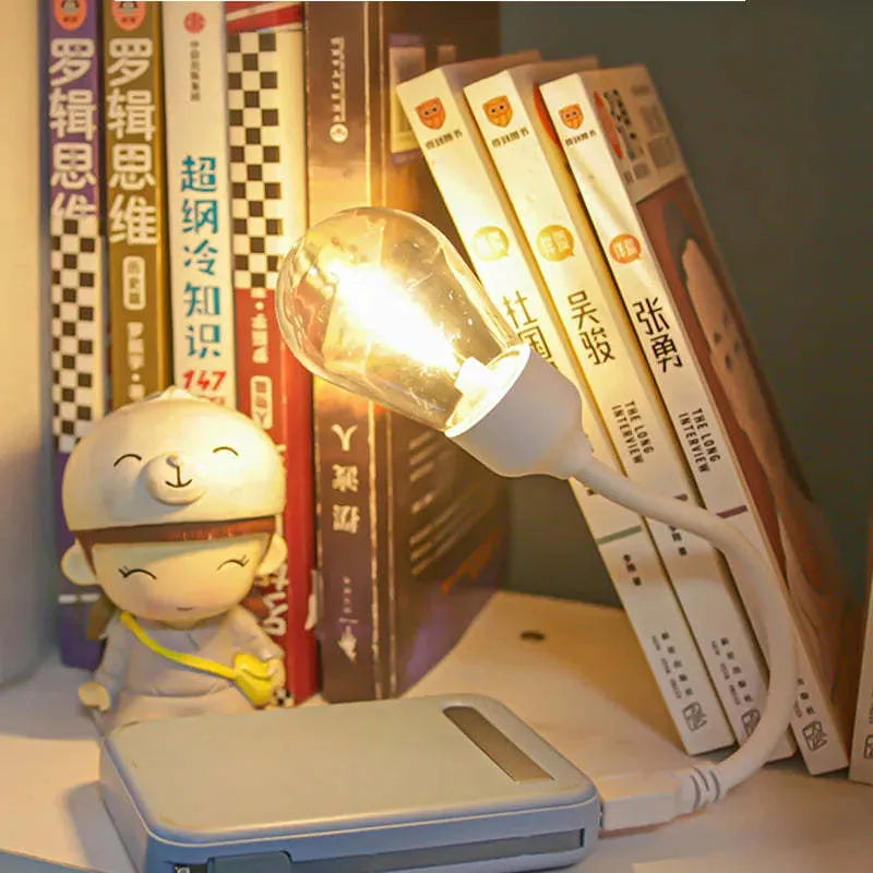 Folding USB rechargeable night light with warm white tungsten bulb, shown in open position.