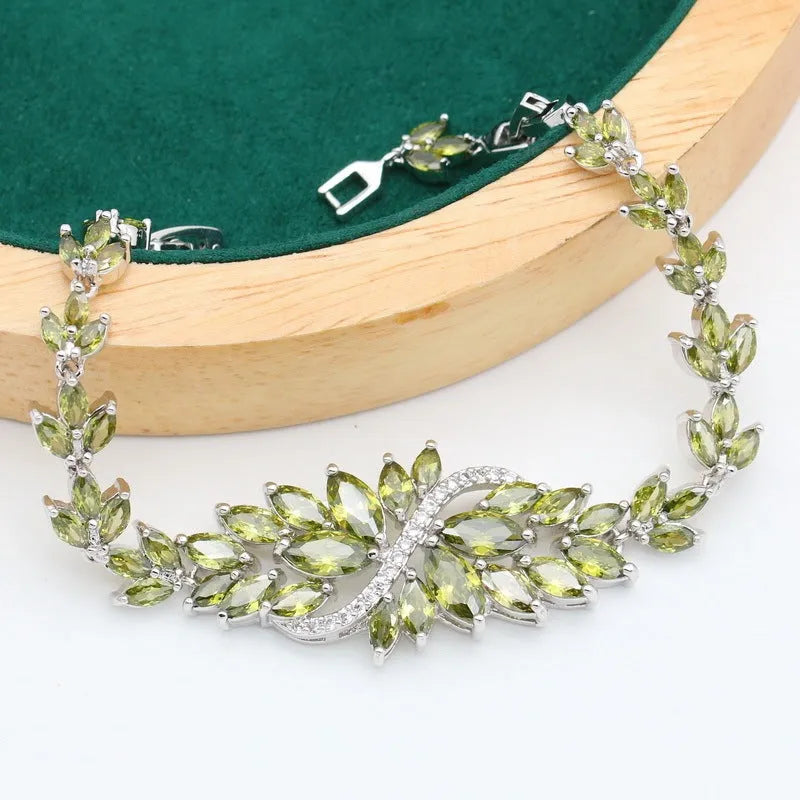 Retro jewellery set with plants and flowers design showing necklace, earrings, ring and bracelet in olive purple colours
